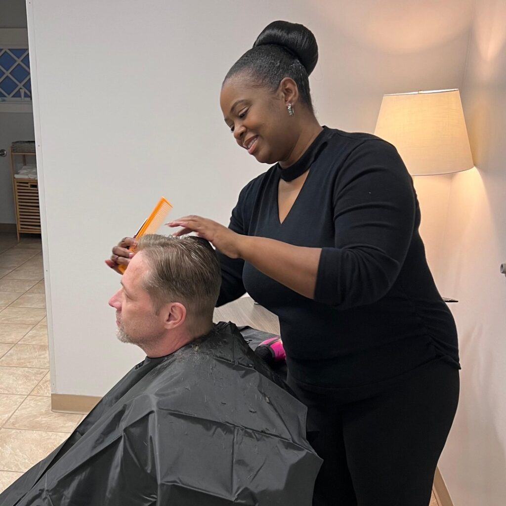 Tiffany Easterling using her talents to provide free haircuts to our guests.